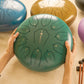 SonodrumSteelTongueDrumStandard-12Inches_11Tongues_CMajor-Hand-Green